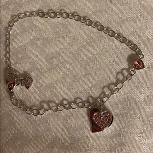 Swarovski Bracelet w/ hanging hearts. 1 pink heart in the middle of bracelet. 8”